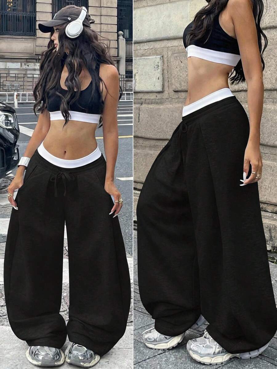 Women's casual black loose fit baggy banana pants featuring a low rise elastic drawstring waist and side pockets.