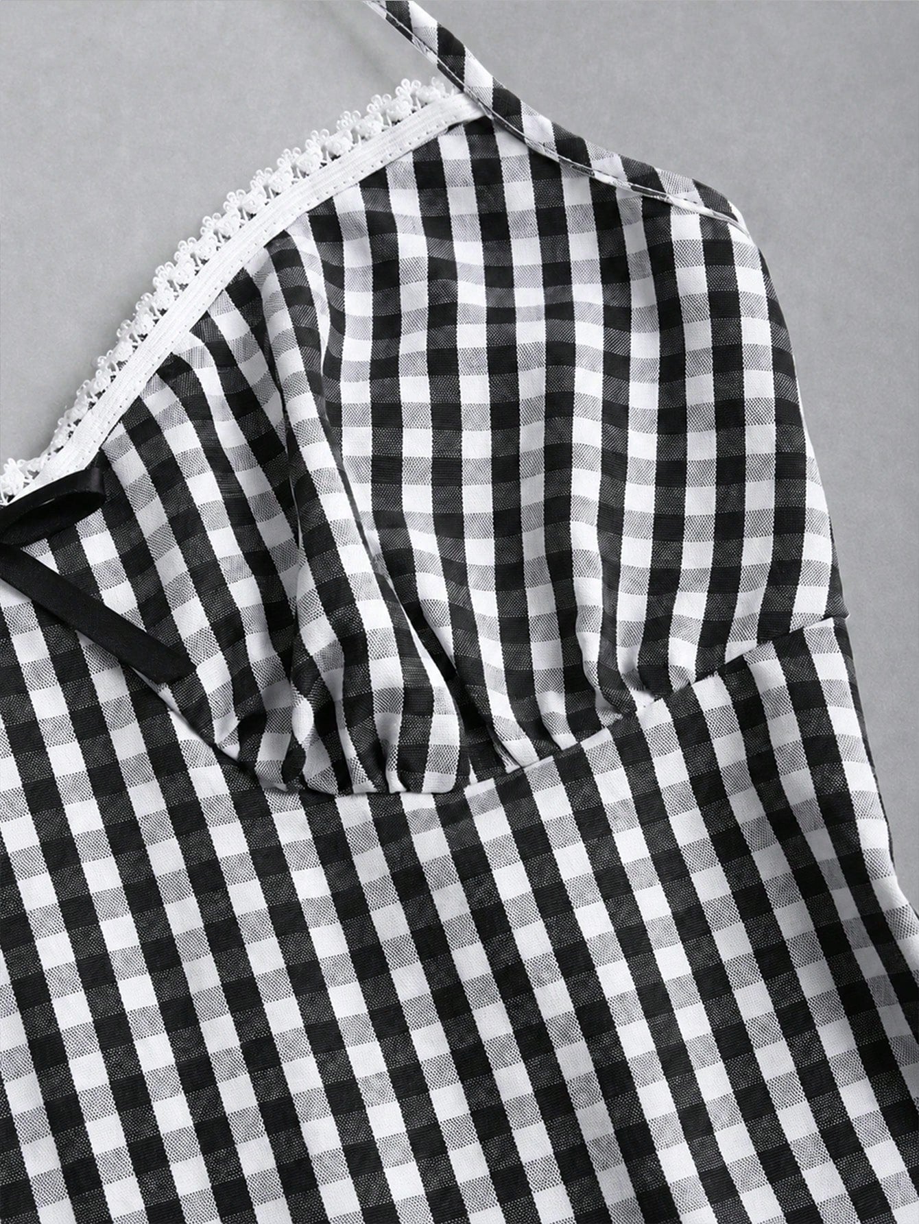 Women's plaid halter tank top with bow trim, knot detail, backless design, and micro crop slim fit.