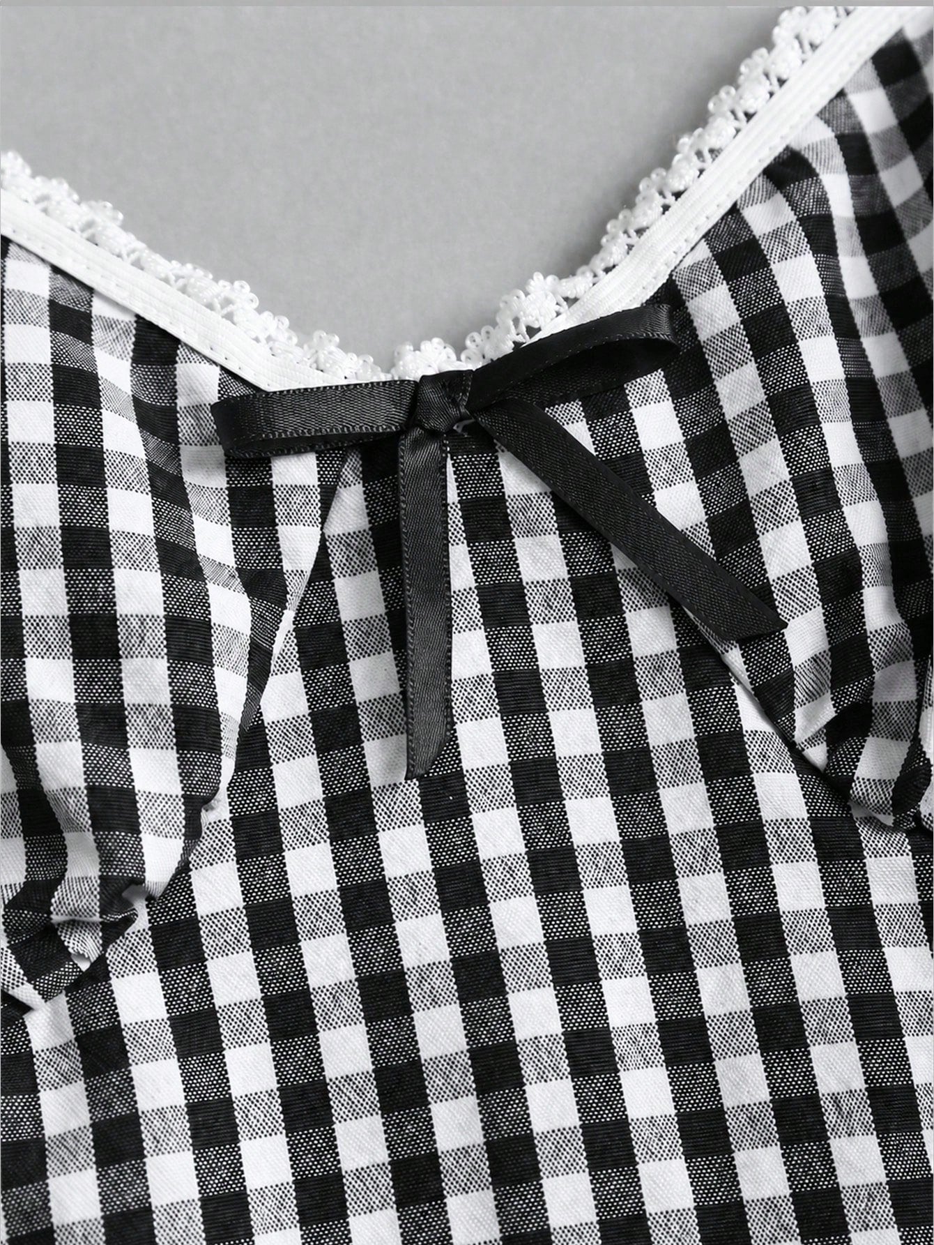 Women's plaid halter tank top with bow trim, knot detail, backless design, and micro crop slim fit.