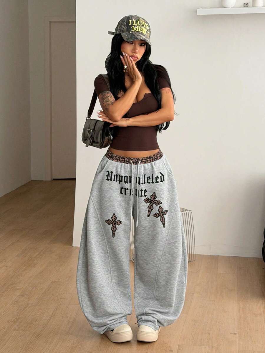 Women's casual grey plaid sweatpants featuring an elastic drawstring waistband, side pockets, and a relaxed loose fit.