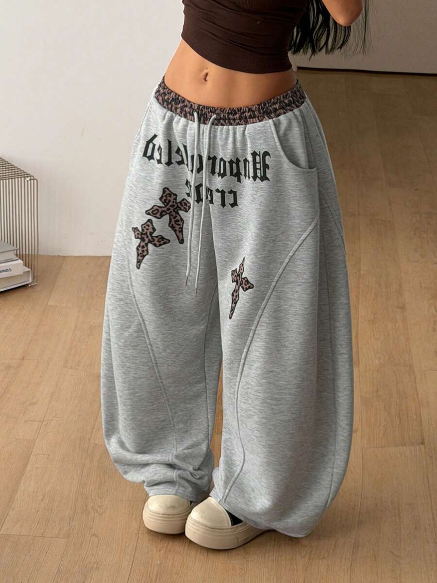 Women's casual grey plaid sweatpants featuring an elastic drawstring waistband, side pockets, and a relaxed loose fit.
