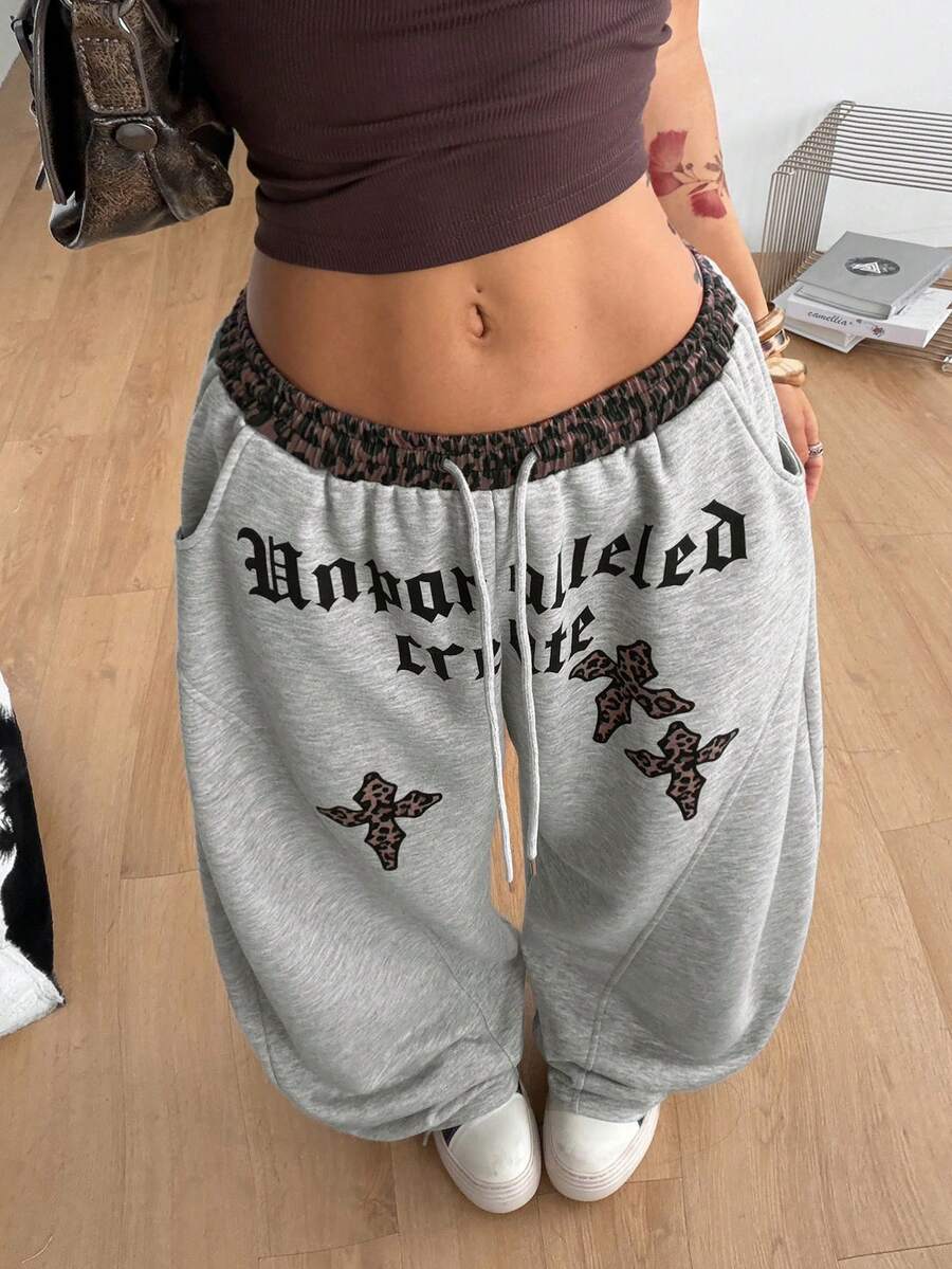 Women's casual grey plaid sweatpants featuring an elastic drawstring waistband, side pockets, and a relaxed loose fit.