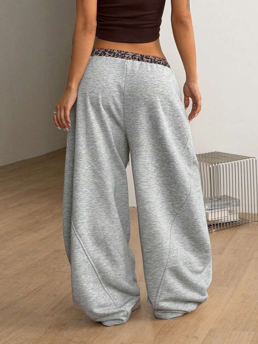 Women's casual grey plaid sweatpants featuring an elastic drawstring waistband, side pockets, and a relaxed loose fit.
