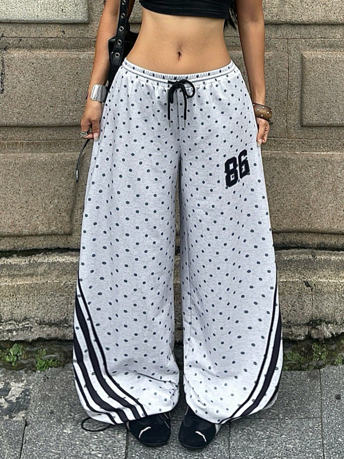 Women's loose fit wide leg graphic sweatpants in light grey with an elastic drawstring waistband