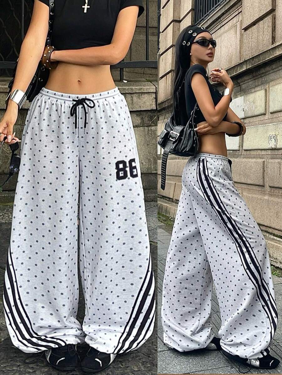 Women's loose fit wide leg graphic sweatpants in light grey with an elastic drawstring waistband