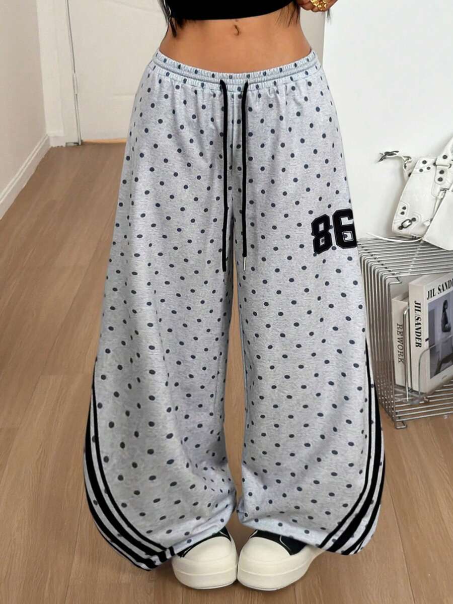 Women's loose fit wide leg graphic sweatpants in light grey with an elastic drawstring waistband