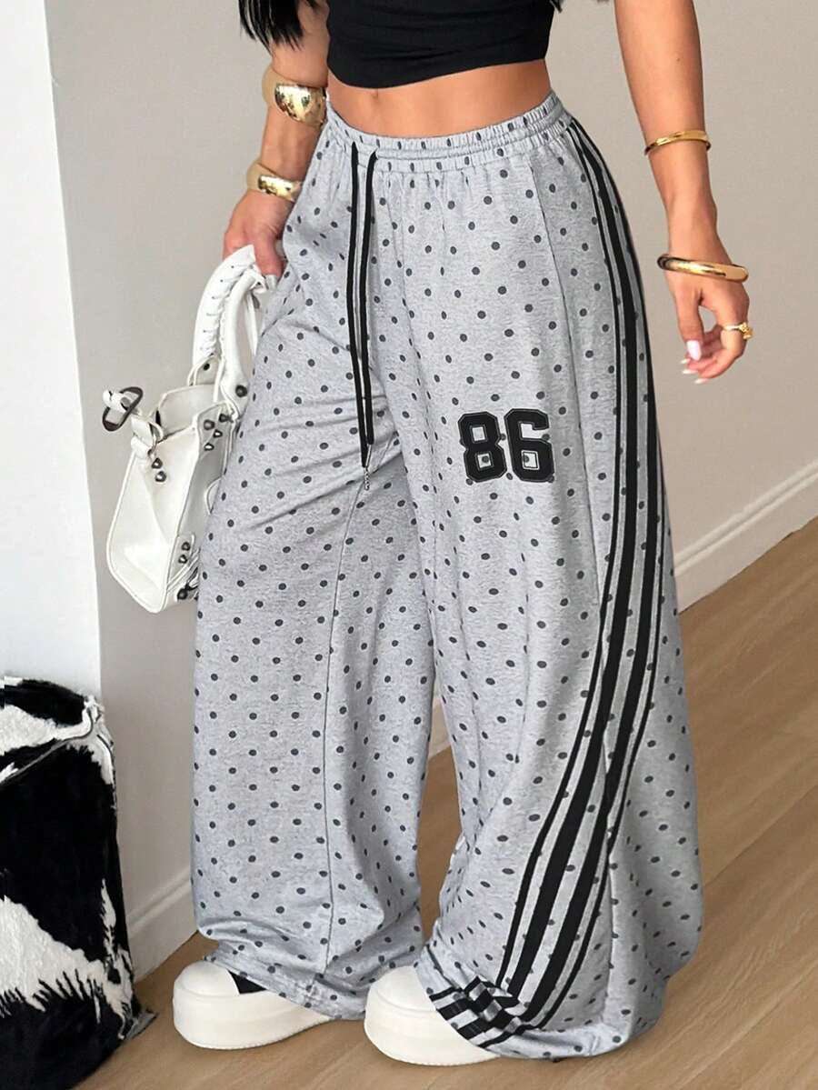 Women's loose fit wide leg graphic sweatpants in light grey with an elastic drawstring waistband