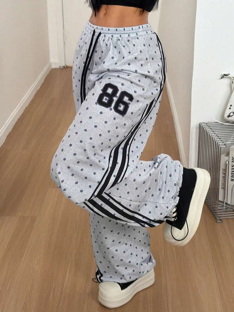 Women's loose fit wide leg graphic sweatpants in light grey with an elastic drawstring waistband