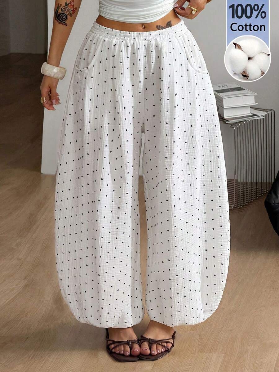 Women's loose-fit black bloomer pants made of 100% cotton featuring an elastic waistband and side pockets.