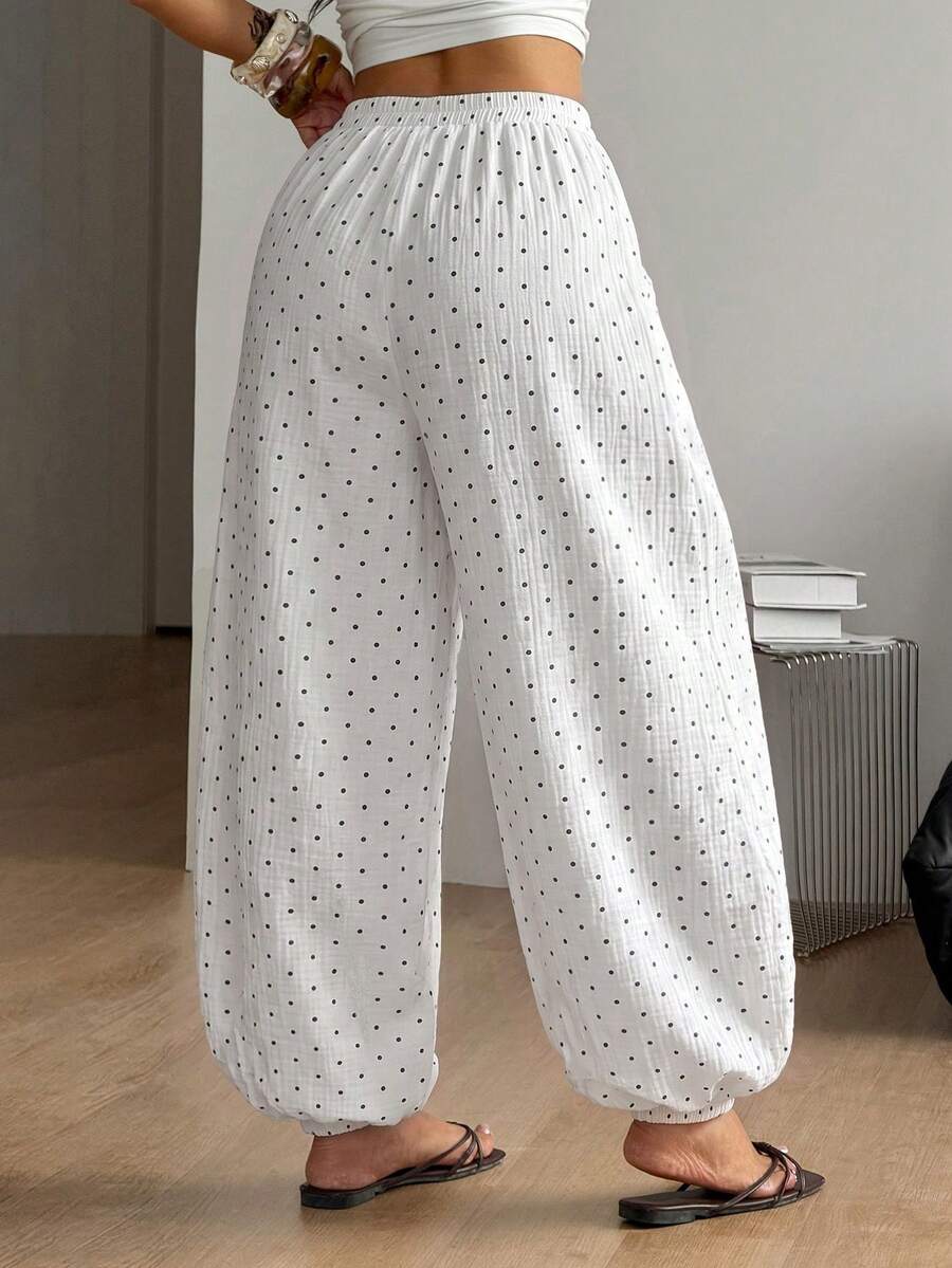 Women's loose-fit black bloomer pants made of 100% cotton featuring an elastic waistband and side pockets.