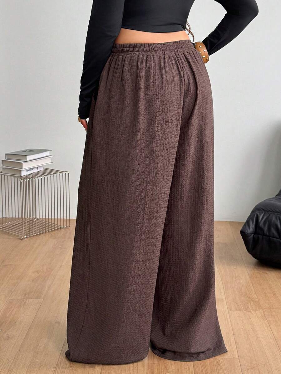 Women's loose straight leg cotton pants featuring a high waist with an adjustable drawstring knot and functional side pockets.
