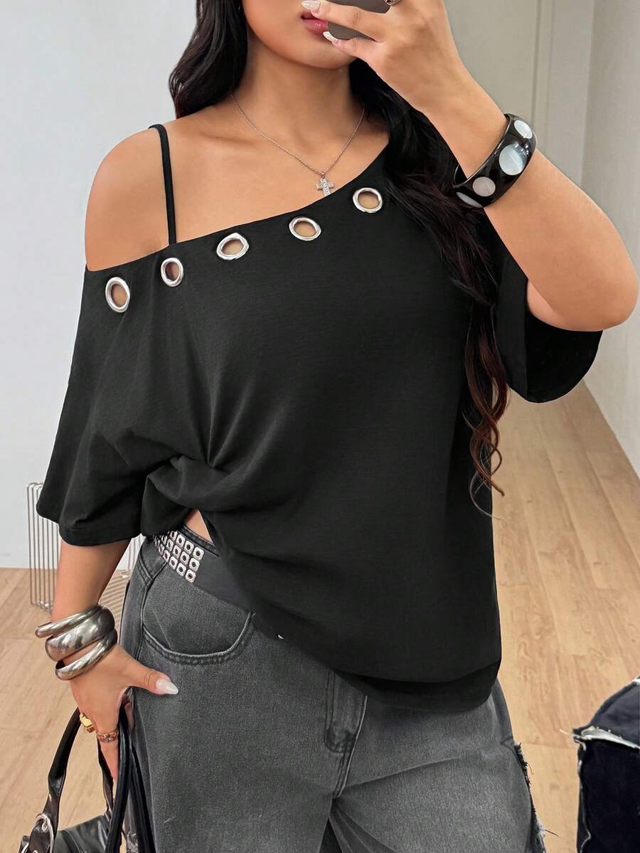 Women's loose-fit black cotton oversized t-shirt featuring an asymmetrical cold shoulder cutout neckline and short drop-shoulder sleeves.
