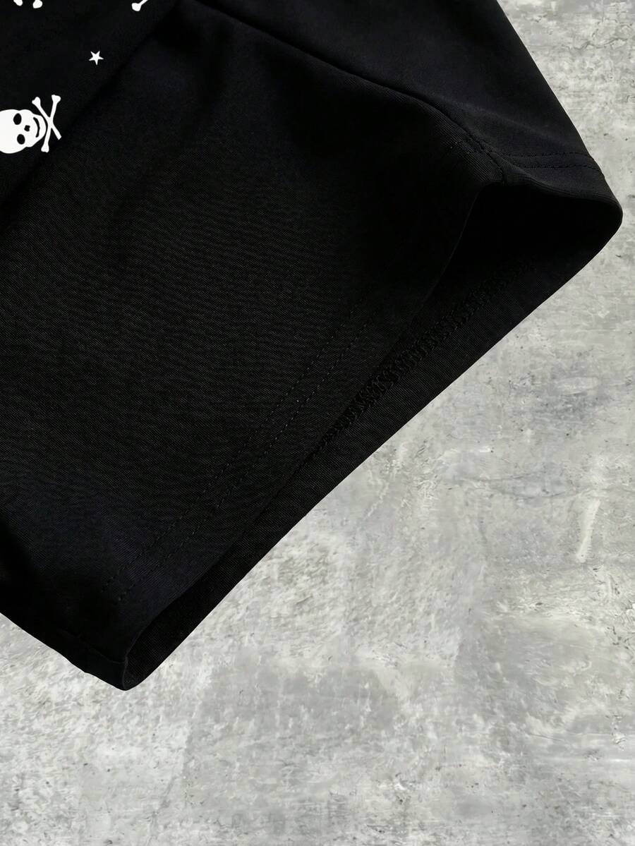 Women's black low waist mini track shorts with contrast polka dot, striped, geometric, and plant-inspired print details, elastic waistband, and skinny fit