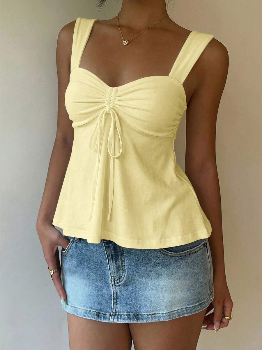 Women's white wide strap tank top with drawstring front, eyelet embroidery, ruffle hem, slim fit, and flared hem.