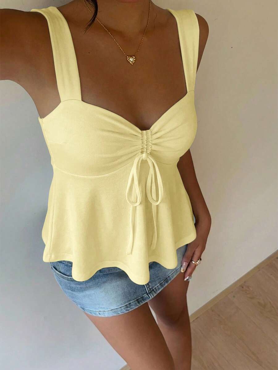 Women's white wide strap tank top with drawstring front, eyelet embroidery, ruffle hem, slim fit, and flared hem.