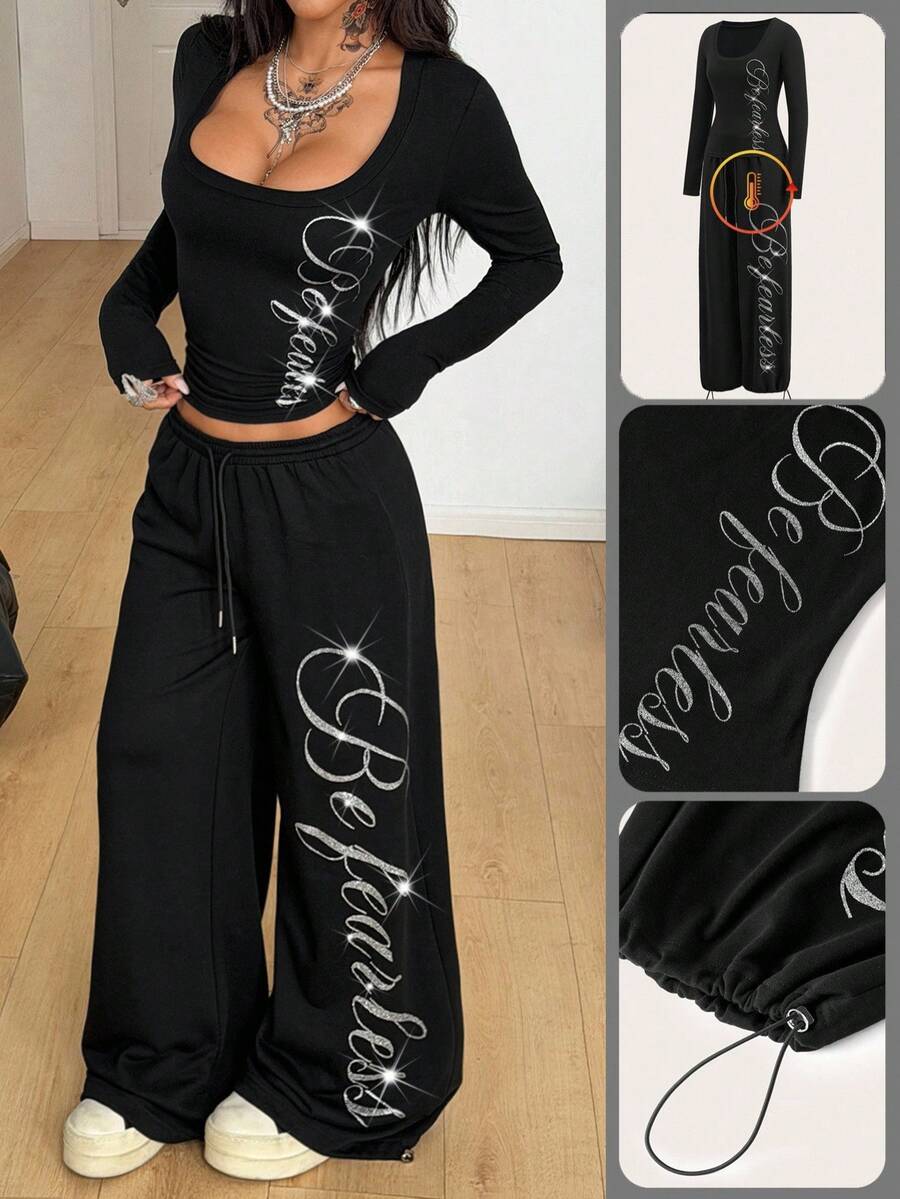 Women's black two-piece casual outfit featuring a long sleeve scoop neck letter print t-shirt and matching wide leg sweatpants made of knitted cotton blend fabric.