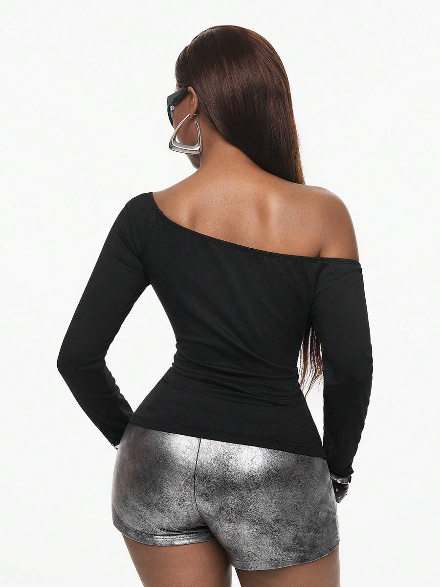 Slim fit women's cold shoulder long sleeve top in black featuring a faux fur hood, ribbed knit texture, and grommet accents.