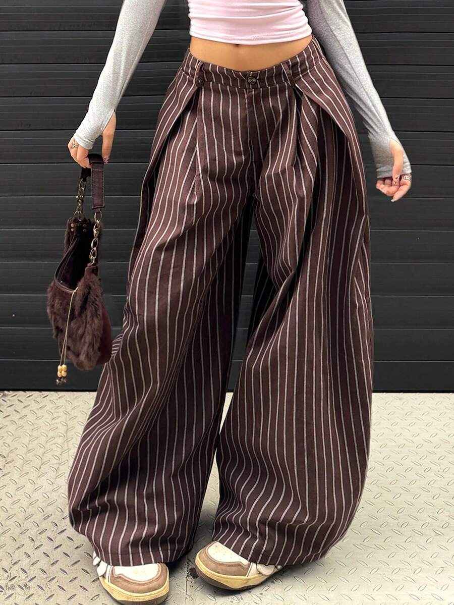 Women's brown striped wide leg pants with a low waist, curved hem, and loose casual fit in woven fabric.