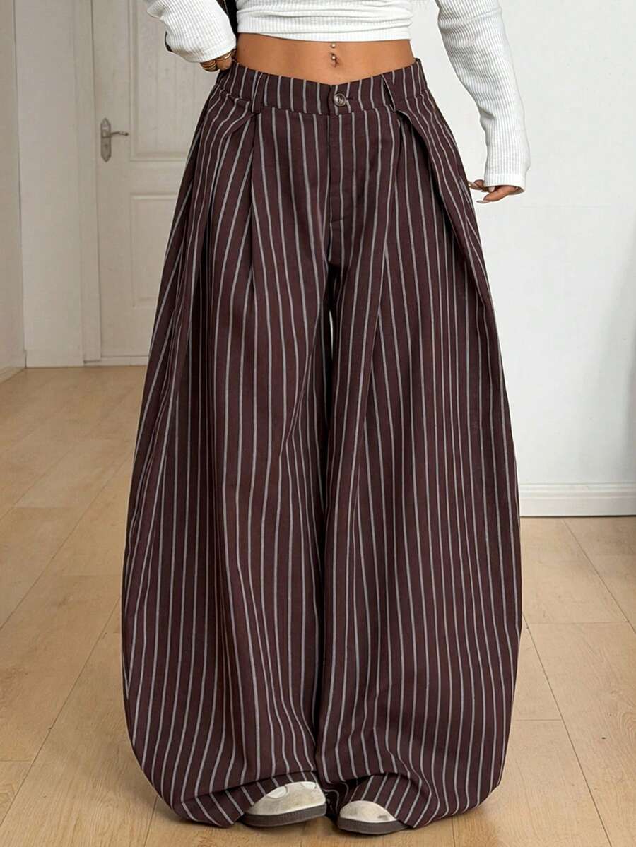 Women's brown striped wide leg pants with a low waist, curved hem, and loose casual fit in woven fabric.
