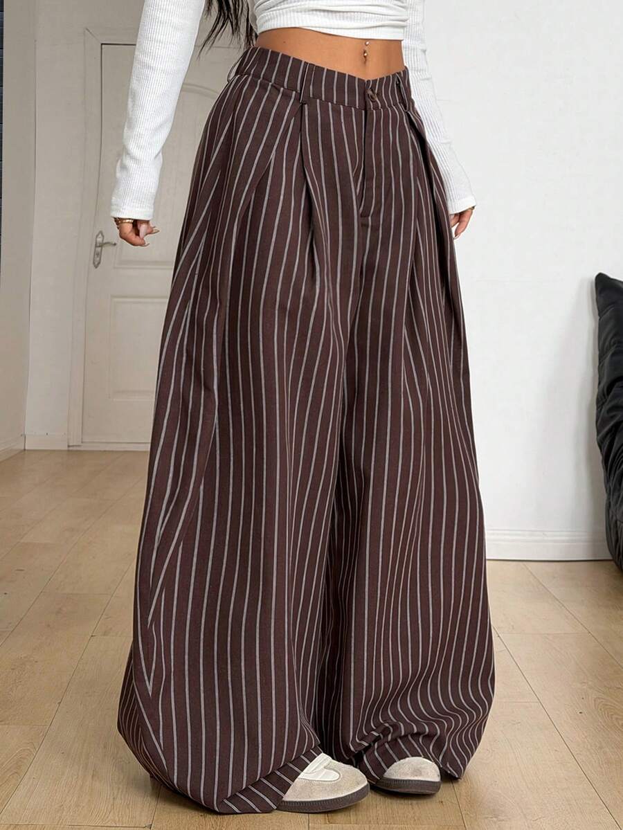 Women's brown striped wide leg pants with a low waist, curved hem, and loose casual fit in woven fabric.