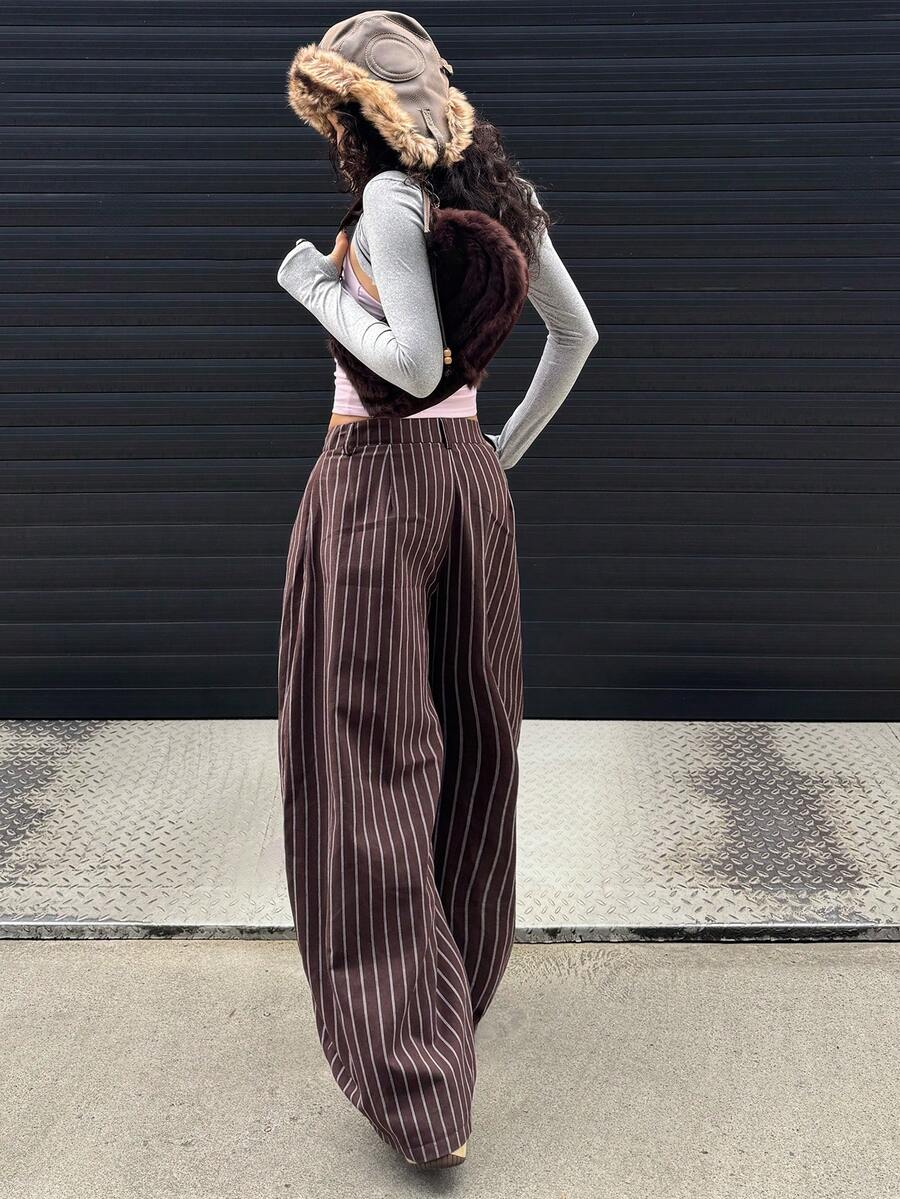 Women's brown striped wide leg pants with a low waist, curved hem, and loose casual fit in woven fabric.