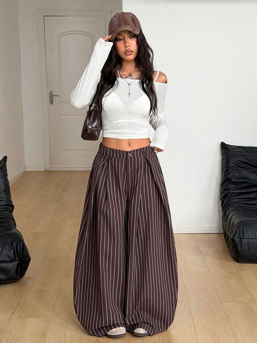 Women's brown striped wide leg pants with a low waist, curved hem, and loose casual fit in woven fabric.