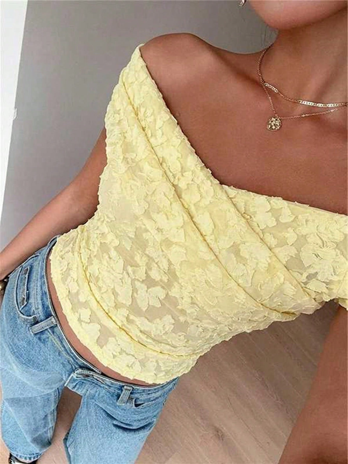 Women's off-the-shoulder slim fit short sleeve t-shirt featuring contrast lace trim and textured knitted fabric.