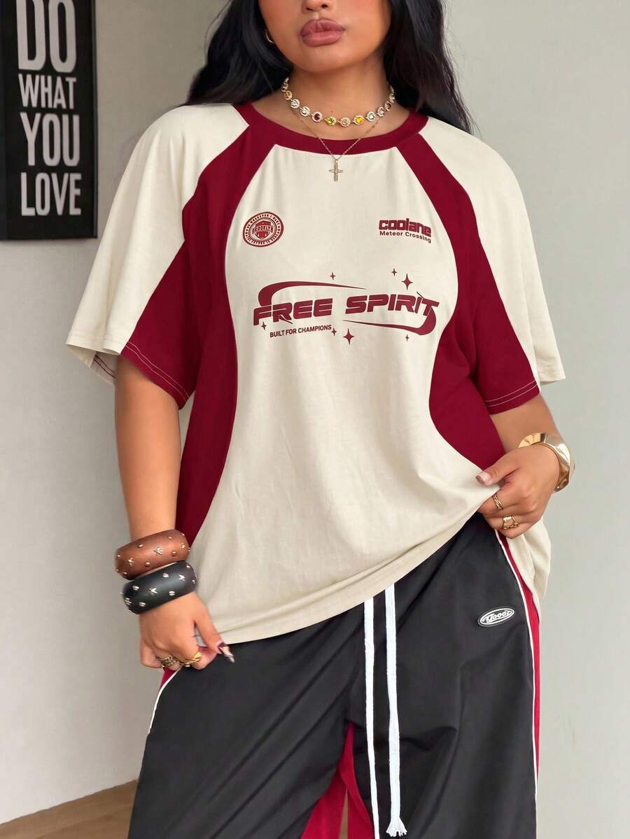 Unisex plus size oversized jersey t-shirt in brown featuring a round neck, short raglan sleeves with contrast binding, and a front letter graphic print.