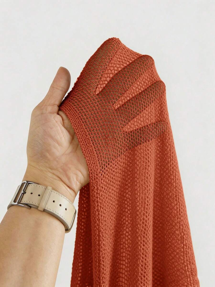 Women's casual hollow knit poncho top with boat neck, cloak sleeves, and asymmetrical hem