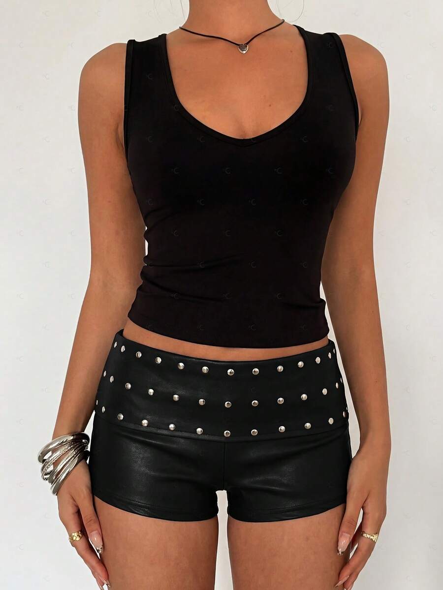 Women's studded PU ultra low waist mini shorts with zipper fly closure, skinny fit, mini length, and plain unlined design.