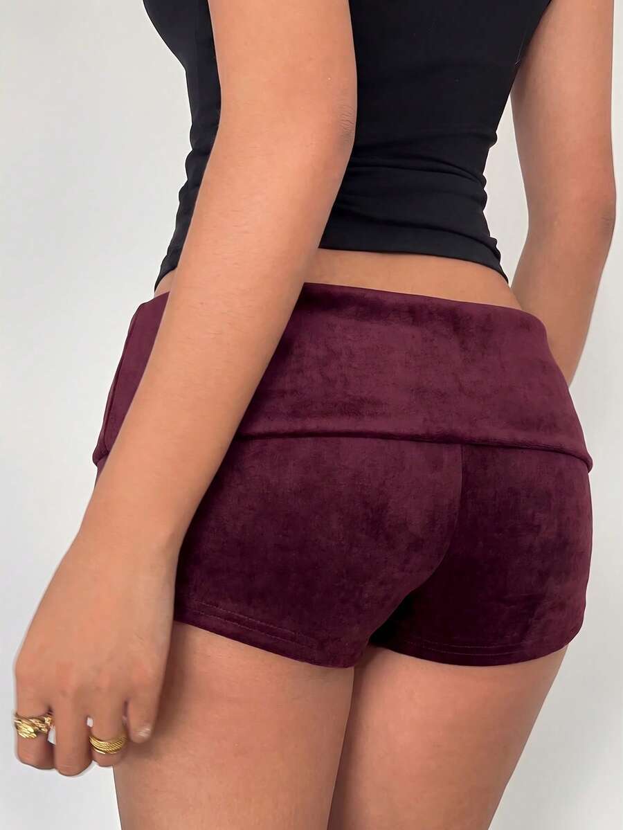 Women's ultra low waist mini shorts with rhinestone studded detailing, skinny fit, and mini length.