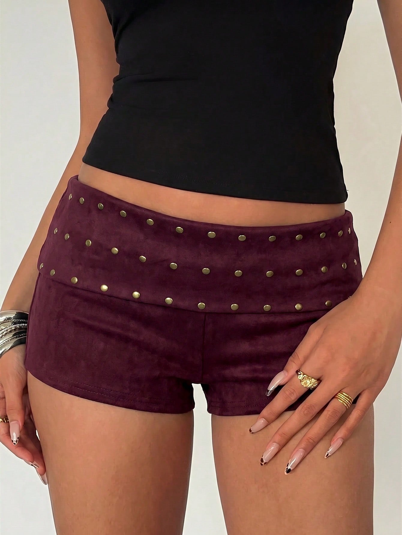 Women's ultra low waist mini shorts with rhinestone studded detailing, skinny fit, and mini length.