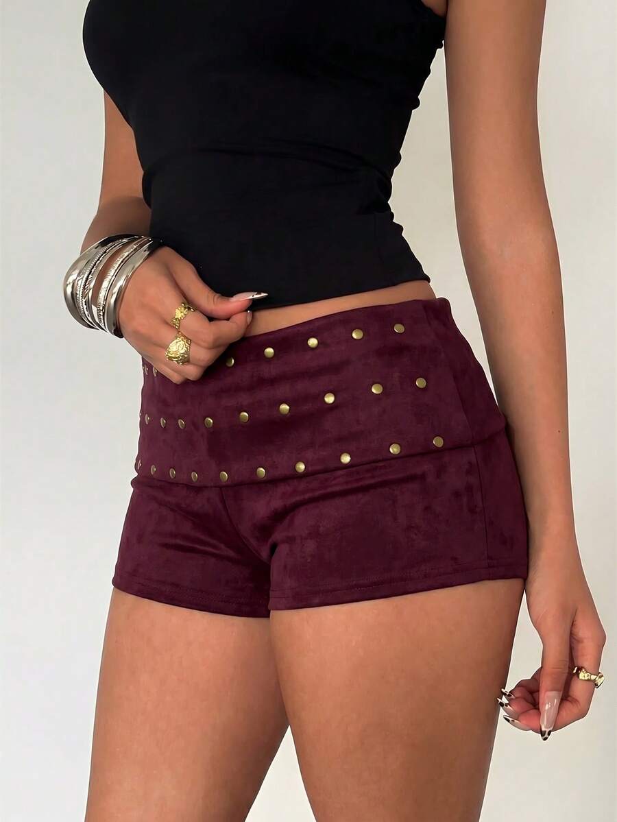 Women's studded PU ultra low waist mini shorts with zipper fly closure, skinny fit, mini length, and plain unlined design.