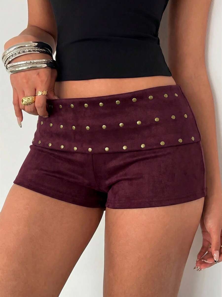 Women's studded PU ultra low waist mini shorts with zipper fly closure, skinny fit, mini length, and plain unlined design.