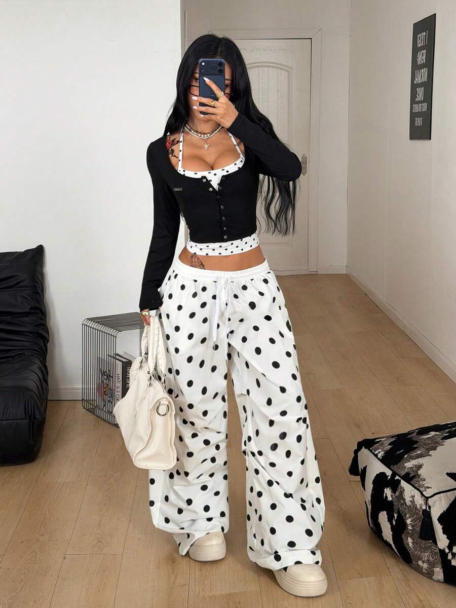 Women's black and white cropped Y2K-style top with lace-up camisole look, halter neckline, long sleeves, button front, rib-knit texture, and slim fit