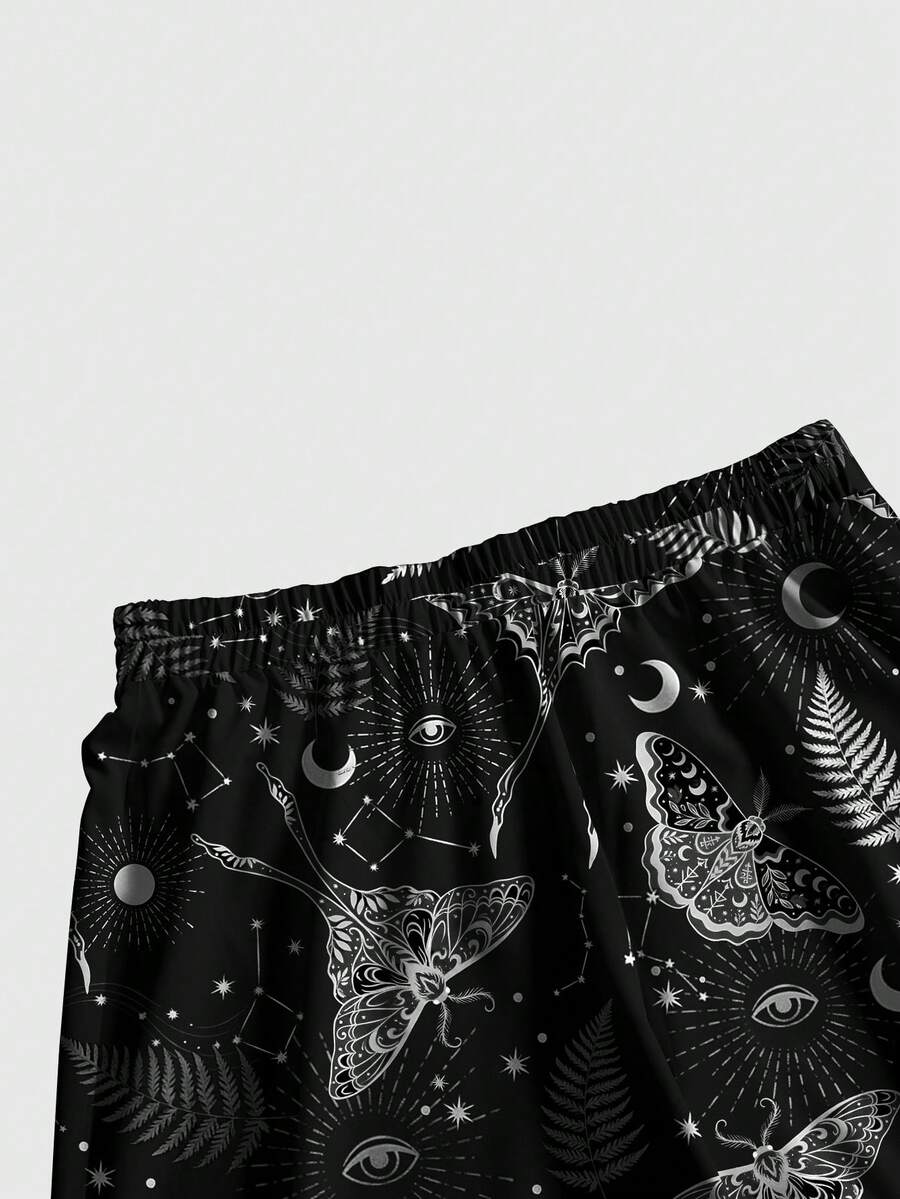 Women's plus size black gothic wide leg pants with split thigh detail and celestial moth, sun, and star pattern.