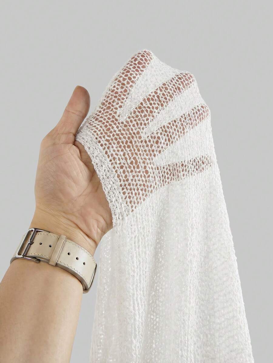 Women's casual hollow knit poncho top with boat neck, cloak sleeves, and asymmetrical hem