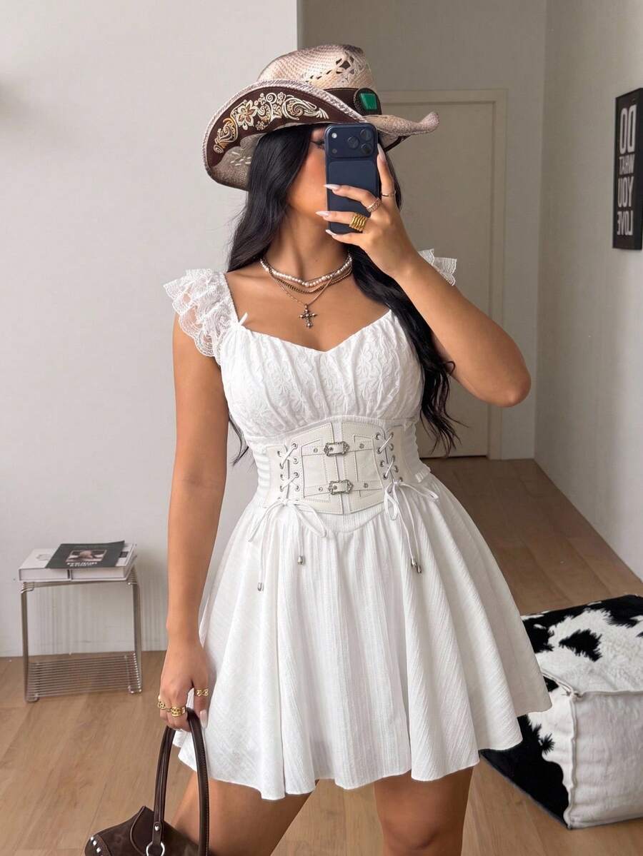 Front view of a white mini dress with sweetheart ruched bust, front lace-up detail, and flounce cap sleeves.