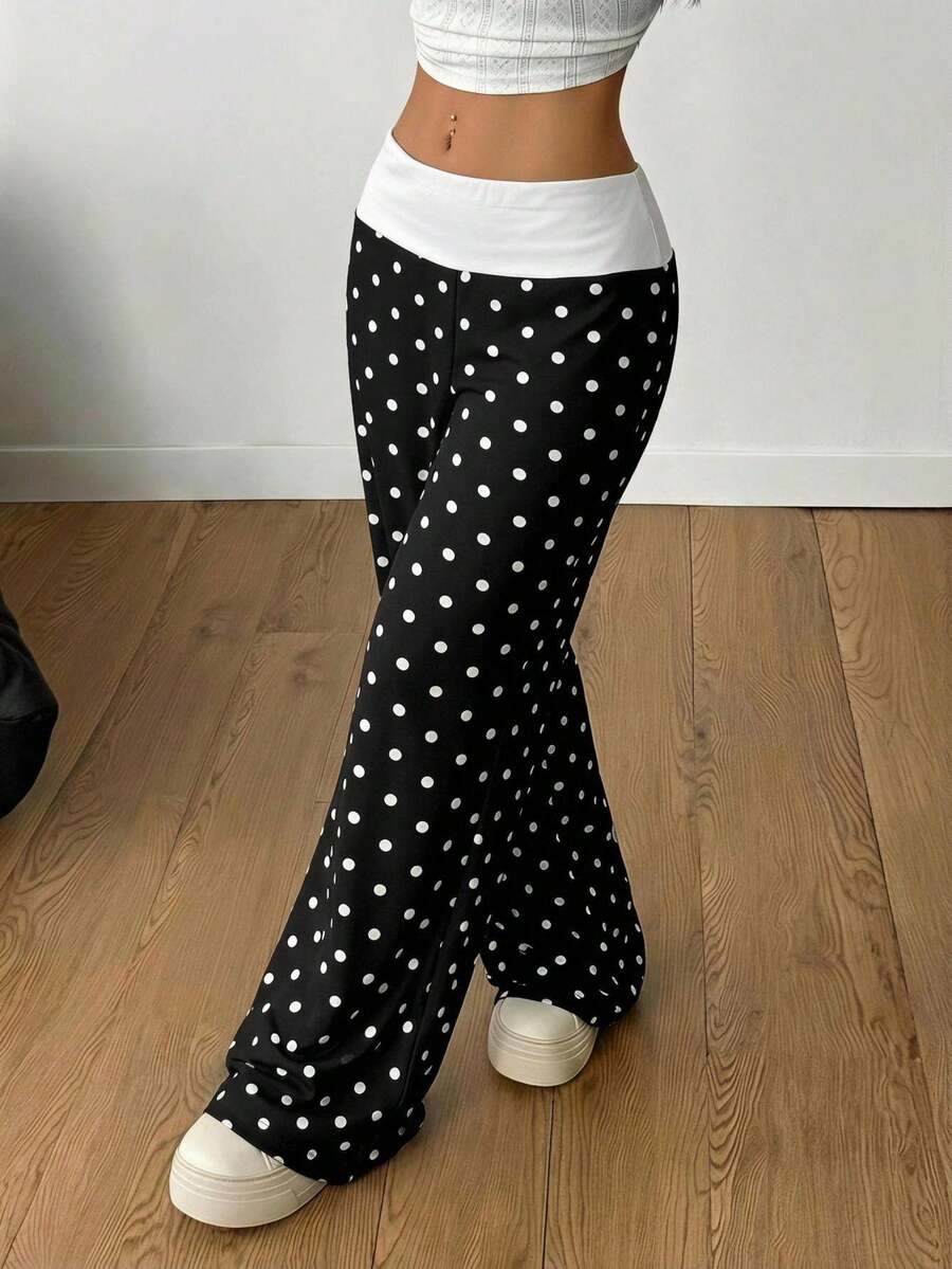 Women's casual straight leg sweatpants featuring a black and white polka dot design with an elastic waistband.
