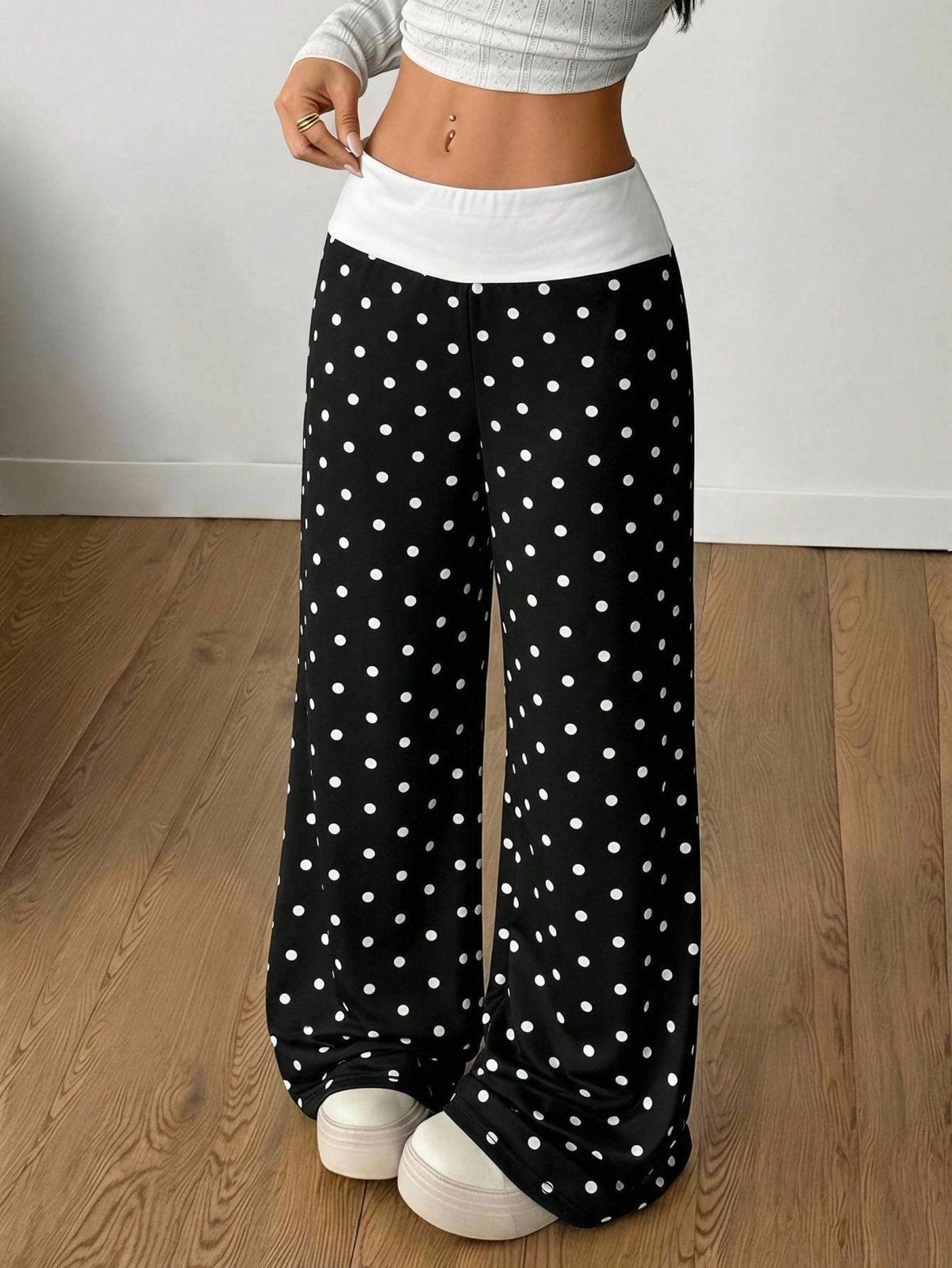 Women's casual straight leg sweatpants featuring a black and white polka dot design with an elastic waistband.