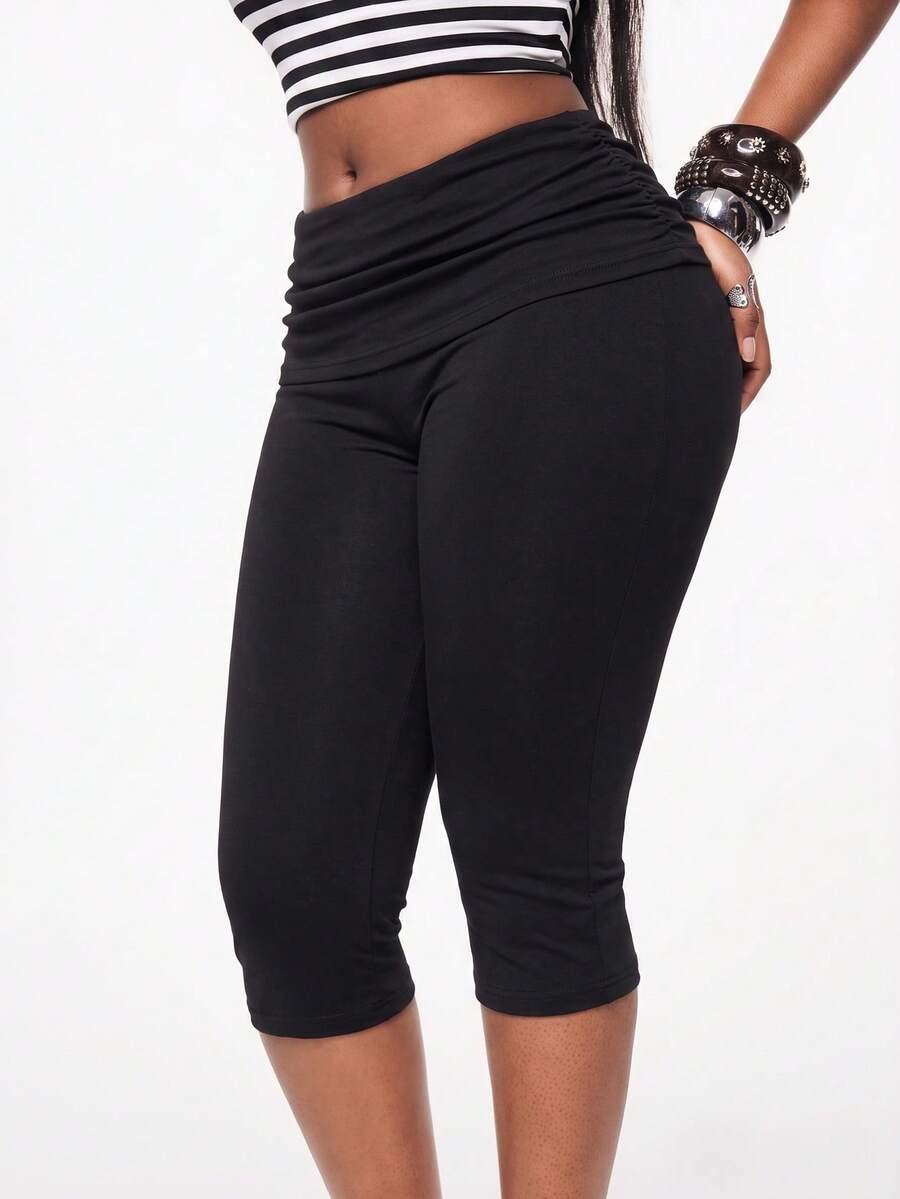 Women's polka dot cropped capri pants in a black and white geometric pattern with an elastic drawstring waist and skinny fit.