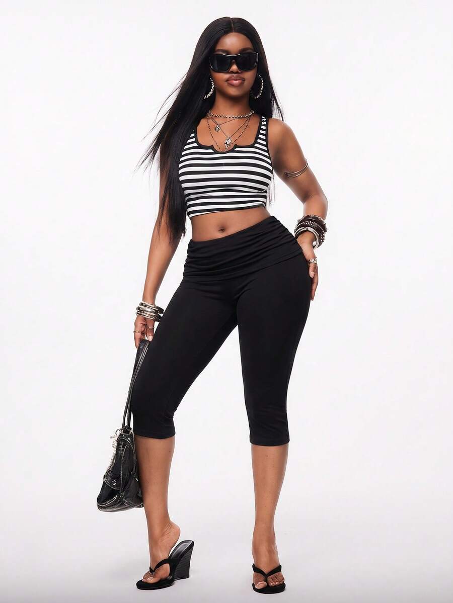 Women's polka dot cropped capri pants in a black and white geometric pattern with an elastic drawstring waist and skinny fit.