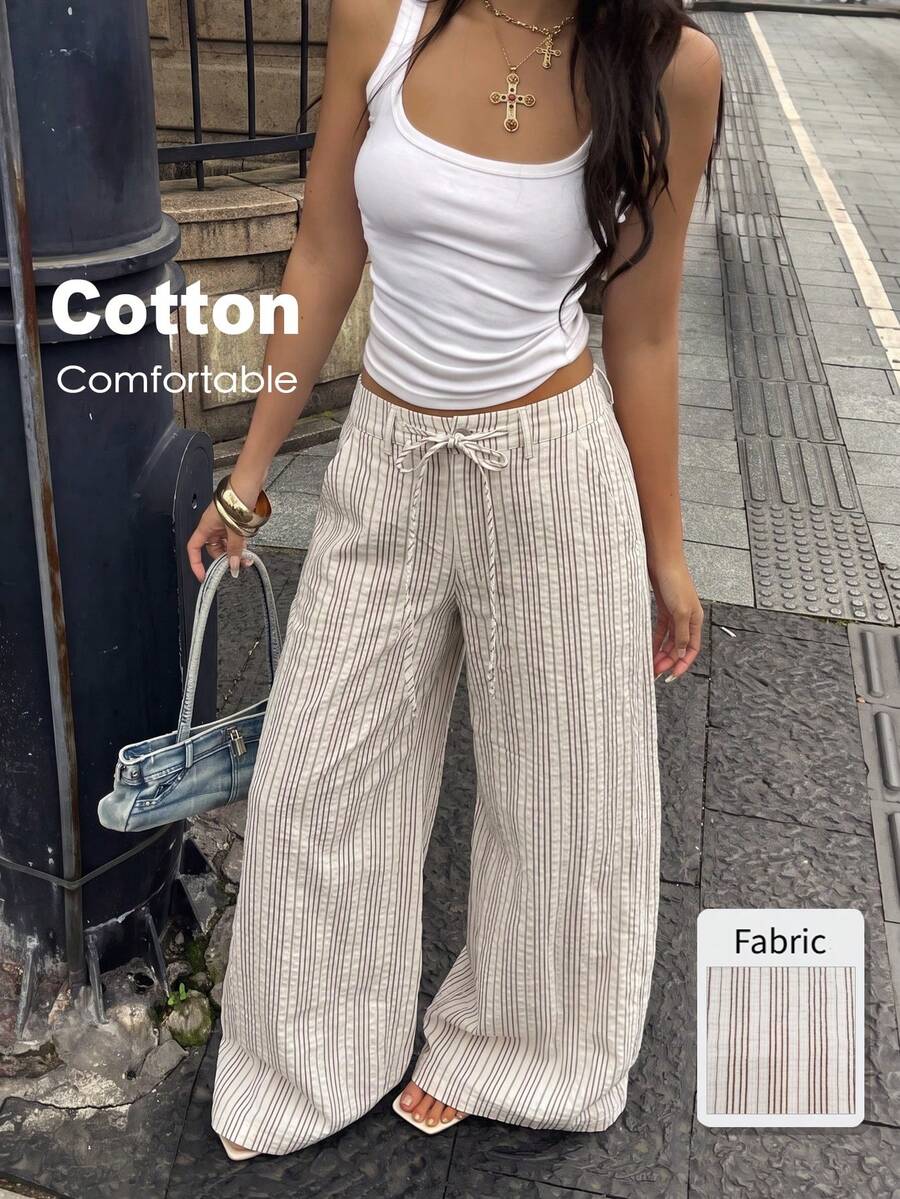 Women's casual straight leg striped woven pants featuring a low waist and zipper fly closure.