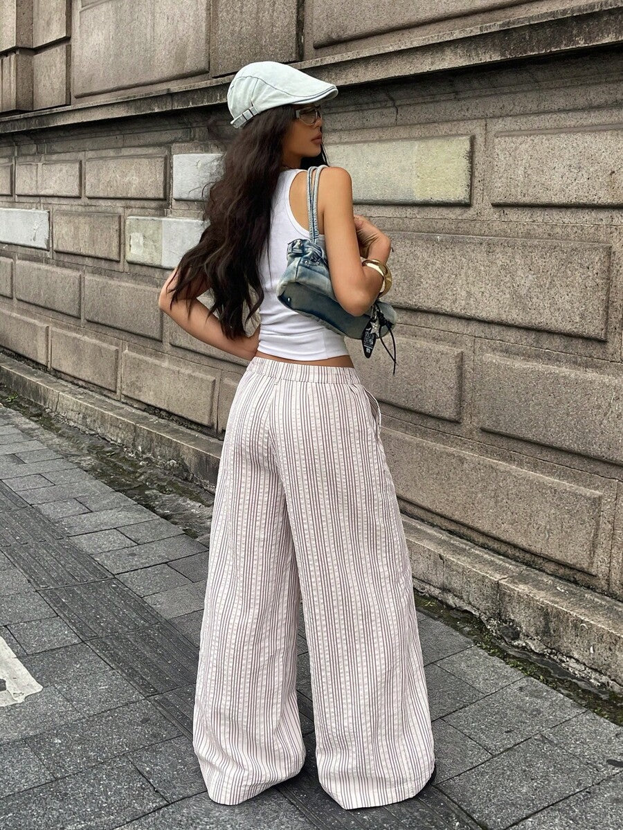 Women's casual straight leg striped woven pants featuring a low waist and zipper fly closure.