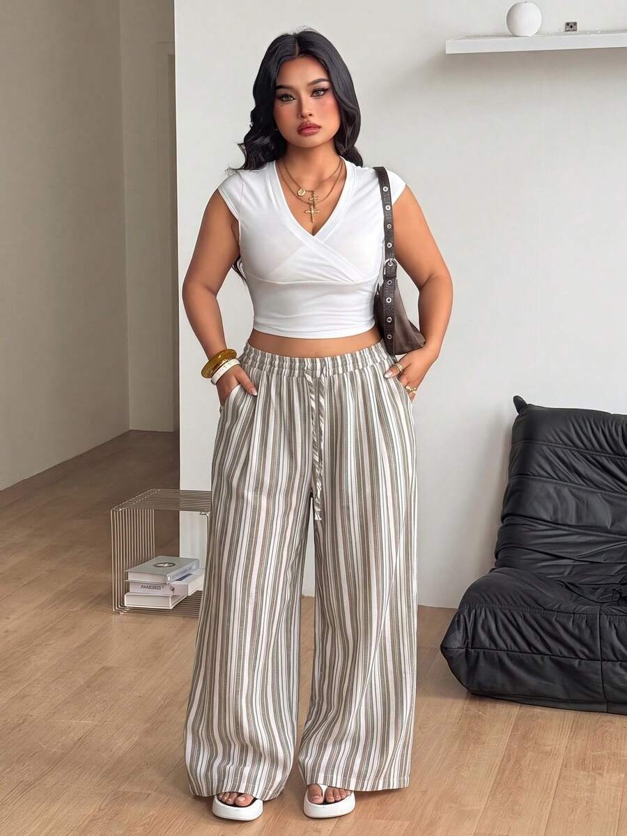 Women's loose straight leg cotton pants featuring a high waist with an adjustable drawstring knot and functional side pockets.