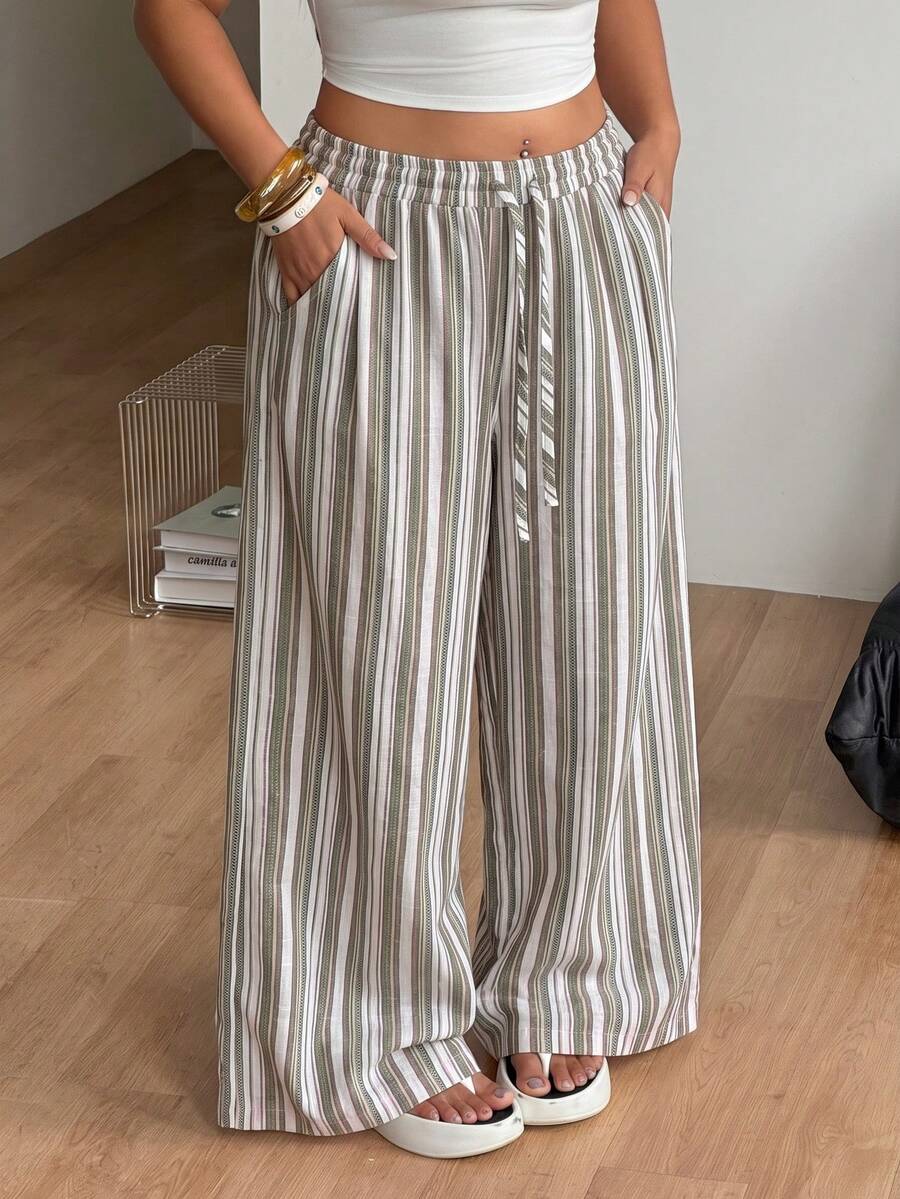 Women's loose straight leg cotton pants featuring a high waist with an adjustable drawstring knot and functional side pockets.