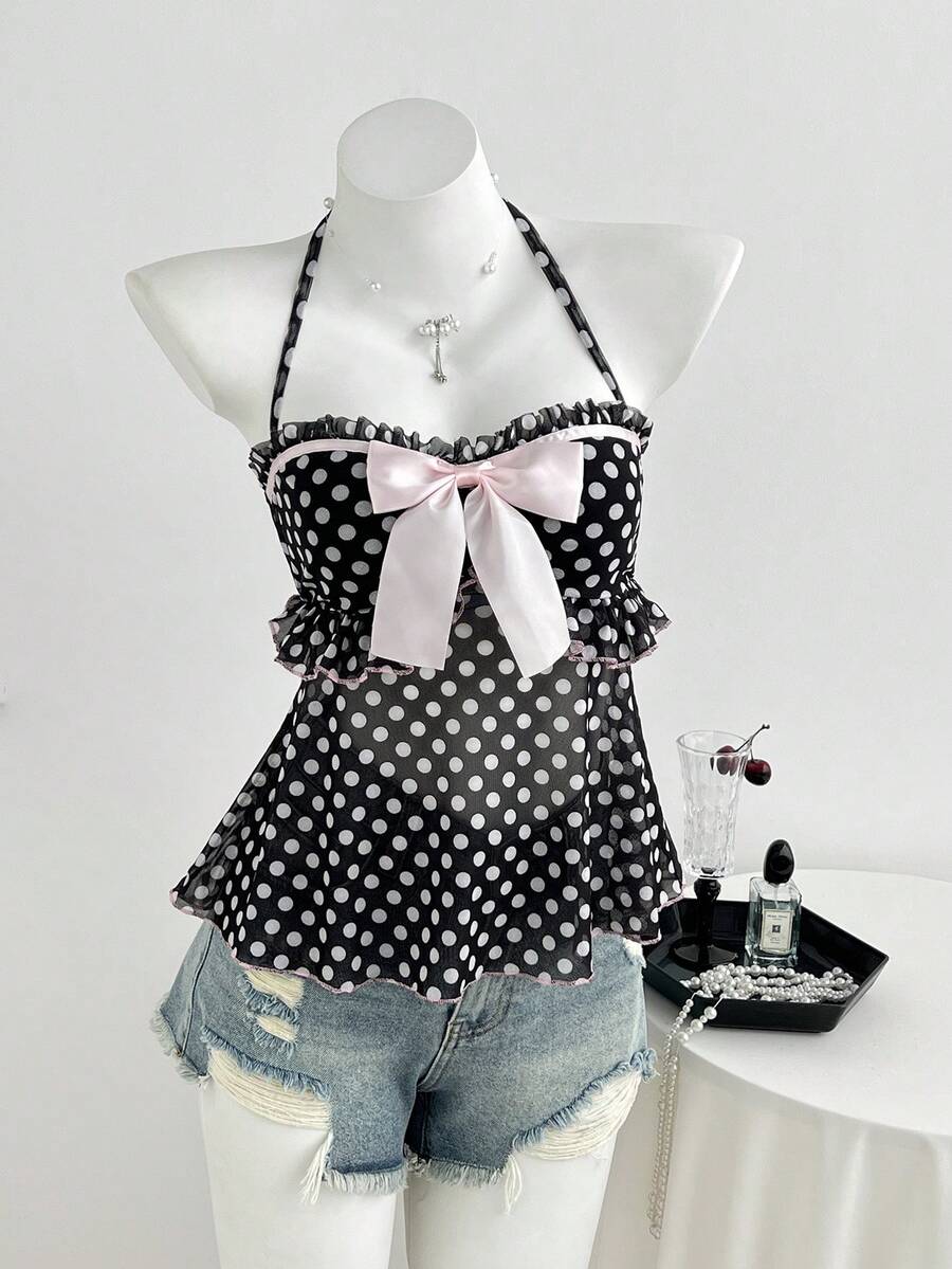 Multicolor polka dot print halter neck tank top featuring a 3D bow accent, backless tie straps, and an asymmetrical ruffle hem.