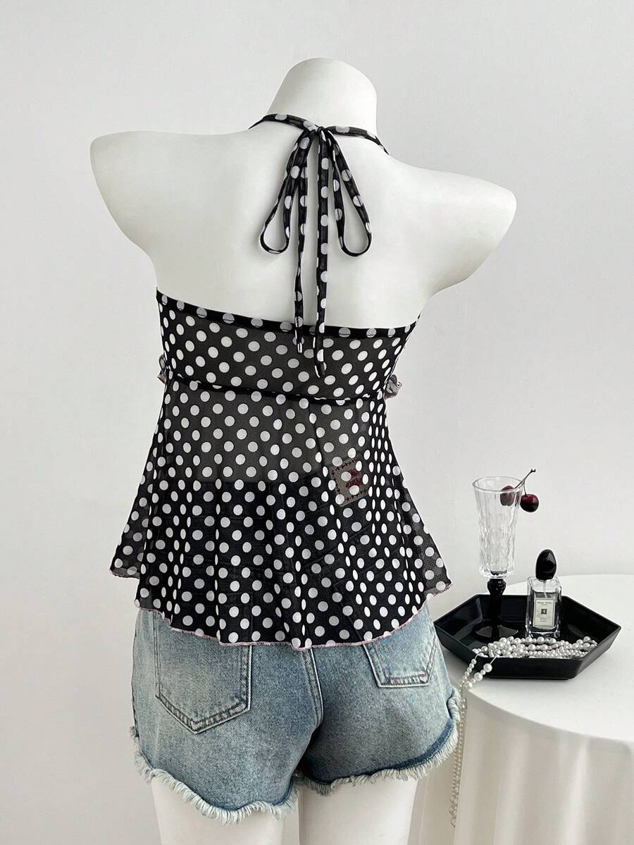 Multicolor polka dot print halter neck tank top featuring a 3D bow accent, backless tie straps, and an asymmetrical ruffle hem.