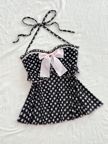 Multicolor polka dot print halter neck tank top featuring a 3D bow accent, backless tie straps, and an asymmetrical ruffle hem.