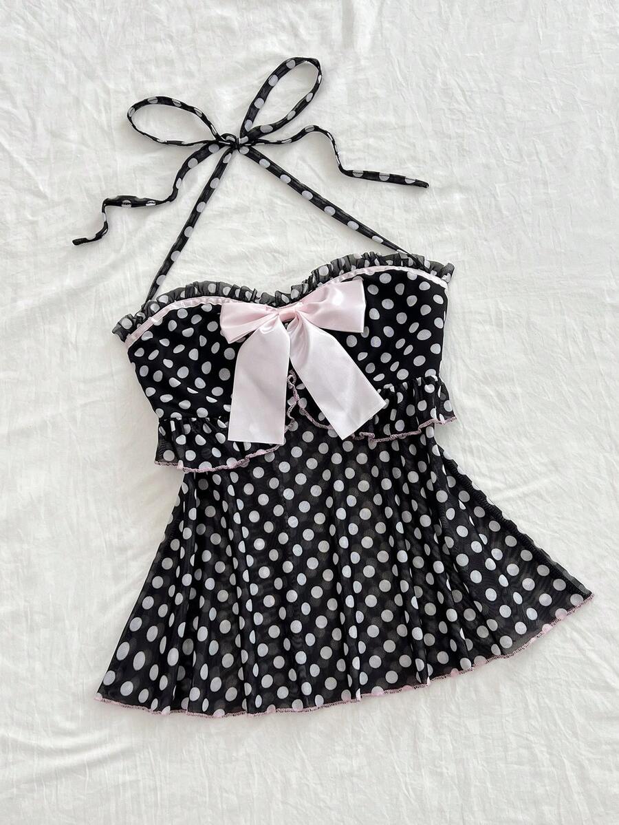 Multicolor polka dot print halter neck tank top featuring a 3D bow accent, backless tie straps, and an asymmetrical ruffle hem.